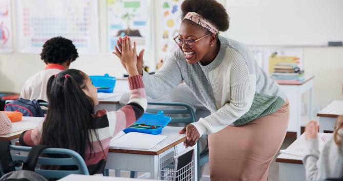 Teacher giving a student a high five