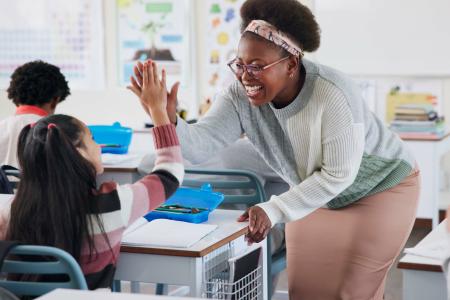 Teacher giving a student a high five