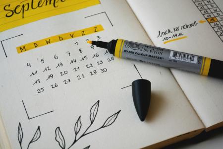 Highlighter and a calendar with checked off dates.